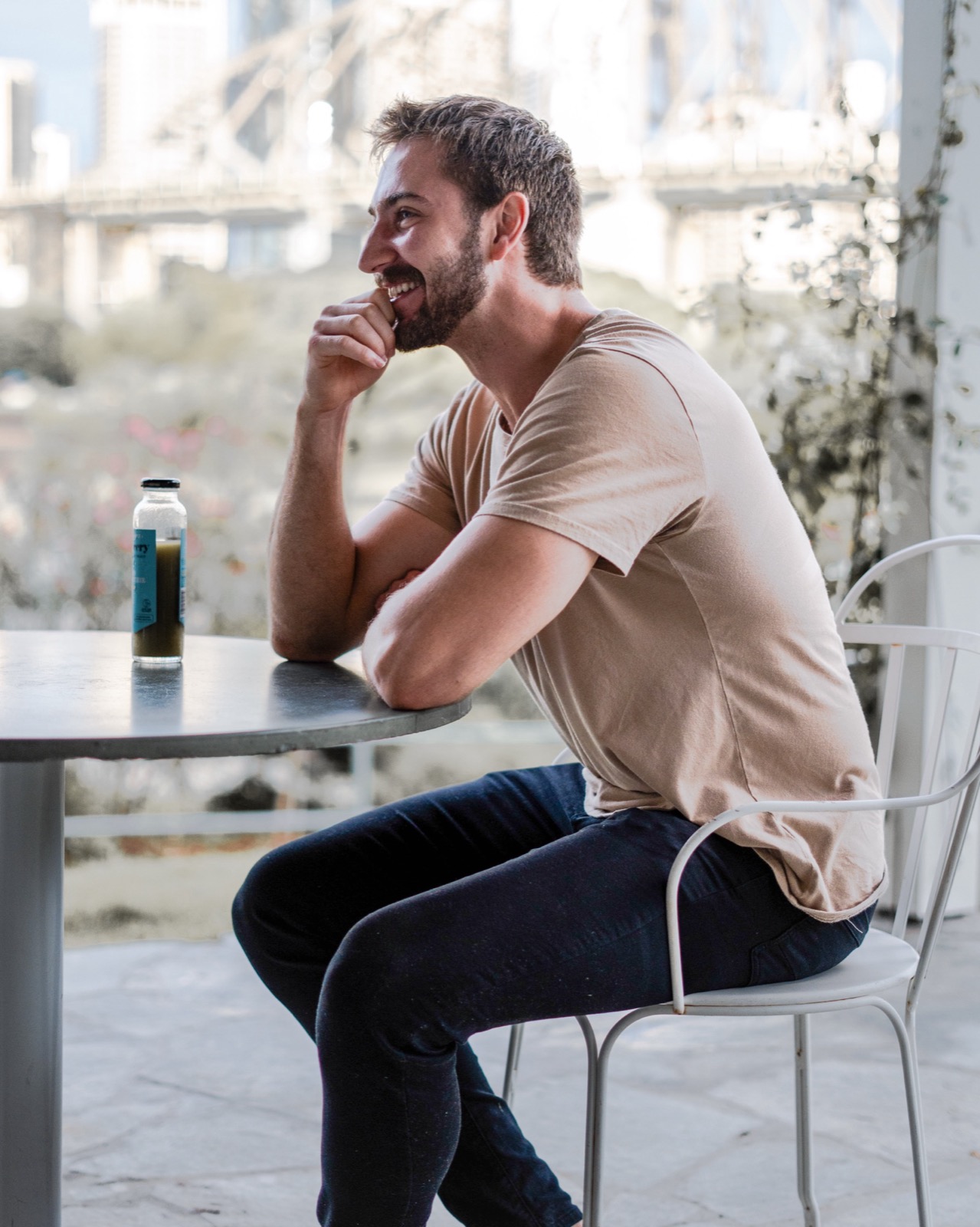 Guy Leggett at a café with the Story Bridge behind